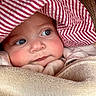 baby, child, face, blue_eyes, blanket, hat, striped_hat, closeup, cute, chubby_cheeks, soft_texture, warm, portrait, infant, clothing, looking_away, indoors, skin, headwear, expression