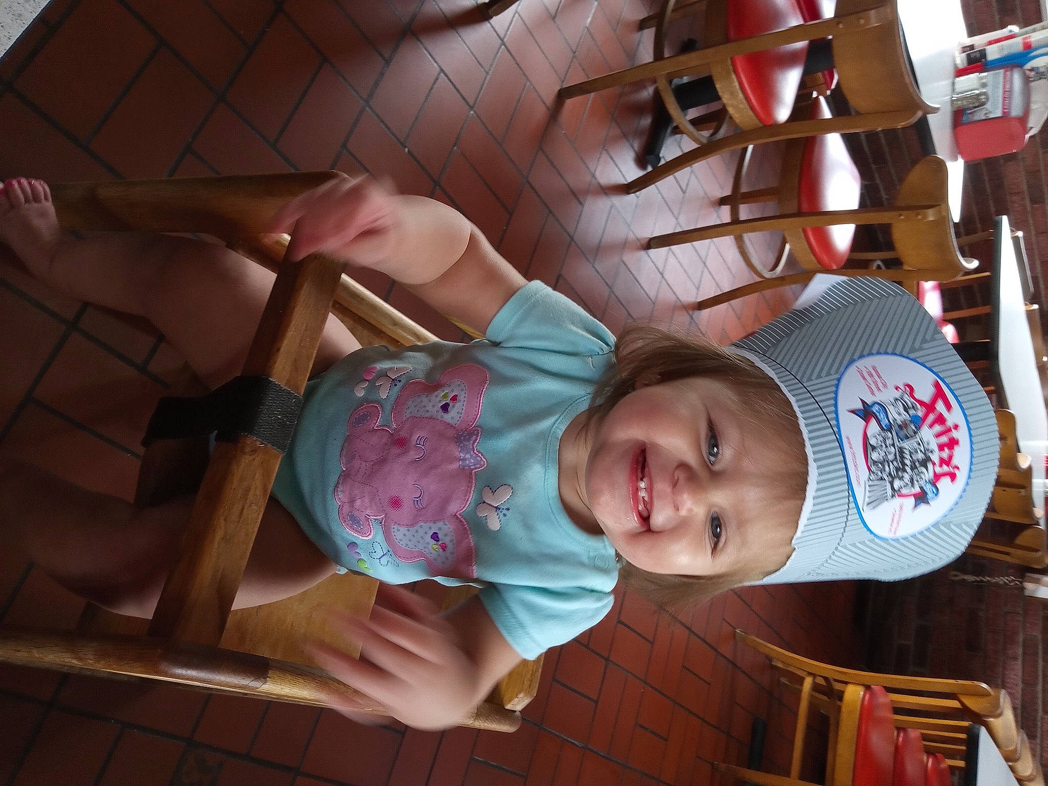 Elizabeth is registered to the contest to win money with this photo: baby, baby_products, baby_toddler_clothing, cap, carmine, child, comfort, fun, happy, hat, headwear, joy, person, room, smile, snapshot, sun_hat, thigh, toddler, wood