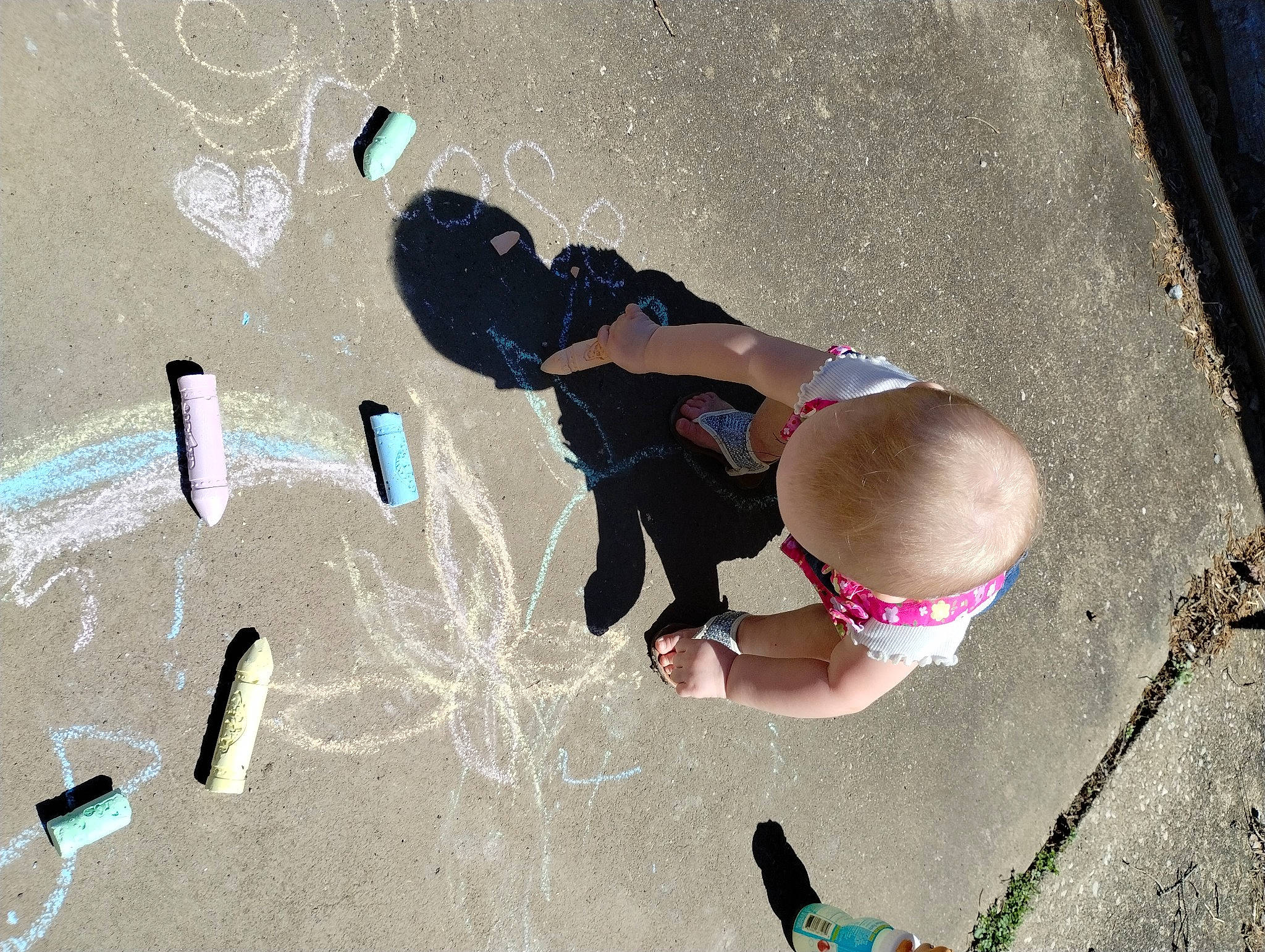 Rose Marie Hale is registered to the contest to win money with this photo: art, asphalt, circle, concrete, cool, finger, fun, gesture, hand, happy, leisure, person, photograph, recreation, road_surface, sand, shadow, sidewalk, snapshot, t_shirt