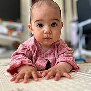 Gloria a rejoint le concours — aidez-le/la à gagner de superbes lots ! baby, infant, child, pink_clothing, floor, hands, face, eyes, indoor, toy, blurred_background, home, crawling, person, young_child, curious, portrait, cute, earrings, soft_light