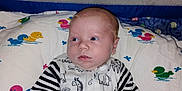Marshall joined the competition — help win amazing prizes! baby, infant, child, blanket, pillow, duck_pattern, onesie, striped_sleeves, animal_print, bed, sleeping_area, cute, indoor, face, head, hands, young_child, soft_texture, lying_down, looking_away