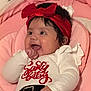 Emily joined the competition — help win amazing prizes! baby, infant, smiling, red_bow, headband, white_shirt, red_pants, santa_baby, cushion, pink_background, hand, happy, cute, indoors, portrait, child, clothing, holiday_outfit, baby_girl, soft_fabric