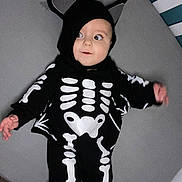 Arlo is registered to the contest to win money with this photo: baby, bodypart, cap, clothing, crib, face, finger, furniture, hand, hat, head, hood, hoodie, infantbed, knitwear, person, photography, portrait, sweater, sweatshirt