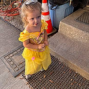 Evelyn is registered to the contest to win money with this photo: accessories, child, clothing, cone, crown, drain, dress, face, female, footwear, girl, hat, head, jewelry, path, person, photography, portrait, shoe, tiara