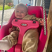 Adalyn is registered to the contest to win money with this photo: baby, child, swing, pink, smiling, outdoor, toy, clothing, cozy, happy, seat, rope, wood, house, building, person, footwear, sock, daylight, playtime