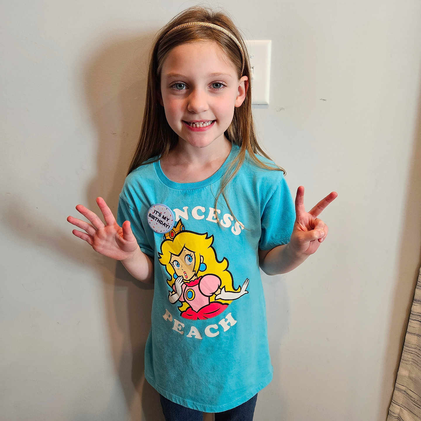 Aubrey is registered to the contest to win money with this photo: bodypart, child, clothing, face, female, finger, girl, hand, happy, head, jeans, longsleeve, pants, person, photography, portrait, shirt, sleeve, smile, t_shirt