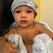 Kyan joined the competition — help win amazing prizes! baby, child, infant, blanket, beanie, hat, face, eyes, mouth, skin, hand, soft, cozy, indoor, portrait, cute, expression, clothing, person, warm