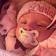 Darlah is registered to the contest to win money with this photo: baby, pacifier, hat, pink_jacket, blanket, sleepy, cozy, child, face, hand, winter_clothing, fur_trim, closeup, infant, cute, warm, soft, portrait, snug, young_child