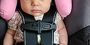 Nova is registered to the contest to win money with this photo: baby, infant, sleeping, car_seat, headband, flower, pink, straps, safety, child, cute, peaceful, clothing, seatbelt, closeup, small_hands, legs, soft_pillow, transportation, resting