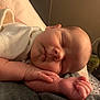 Nova is registered to the contest to win money with this photo: baby, sleeping, infant, hand, blanket, face, cheek, arm, cozy, soft, resting, closeup, indoors, warm_lighting, peaceful, newborn, portrait, person, skin, quiet
