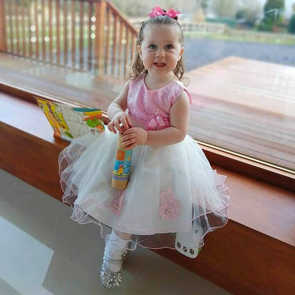 Maisy joined the competition — help win amazing prizes! baby, baby_toddler_clothing, beauty, bridal_accessory, child, dress, event, face, fun, happy, headpiece, iris, joy, leisure, magenta, organ, person, pink, sitting, skin