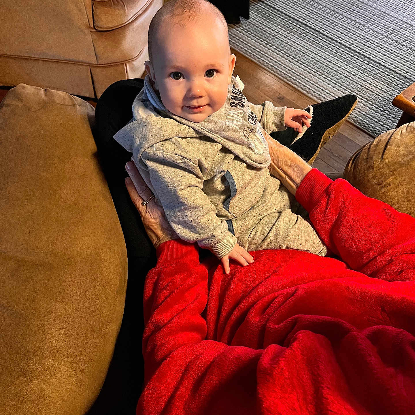 Asher is registered to the contest to win money with this photo: armchair, baby, blanket, chair, clothing, couch, cushion, face, footwear, furniture, head, homedecor, pants, person, photography, portrait, quilt, shoe, sitting, velvet