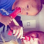 adult, black_shirt, blonde_hair, blue_shirt, child, door, eating, face, hair, hand, happy, indoor, person, popsicle, red_popsicle, room, snack, summer, sunlight, wall_clock