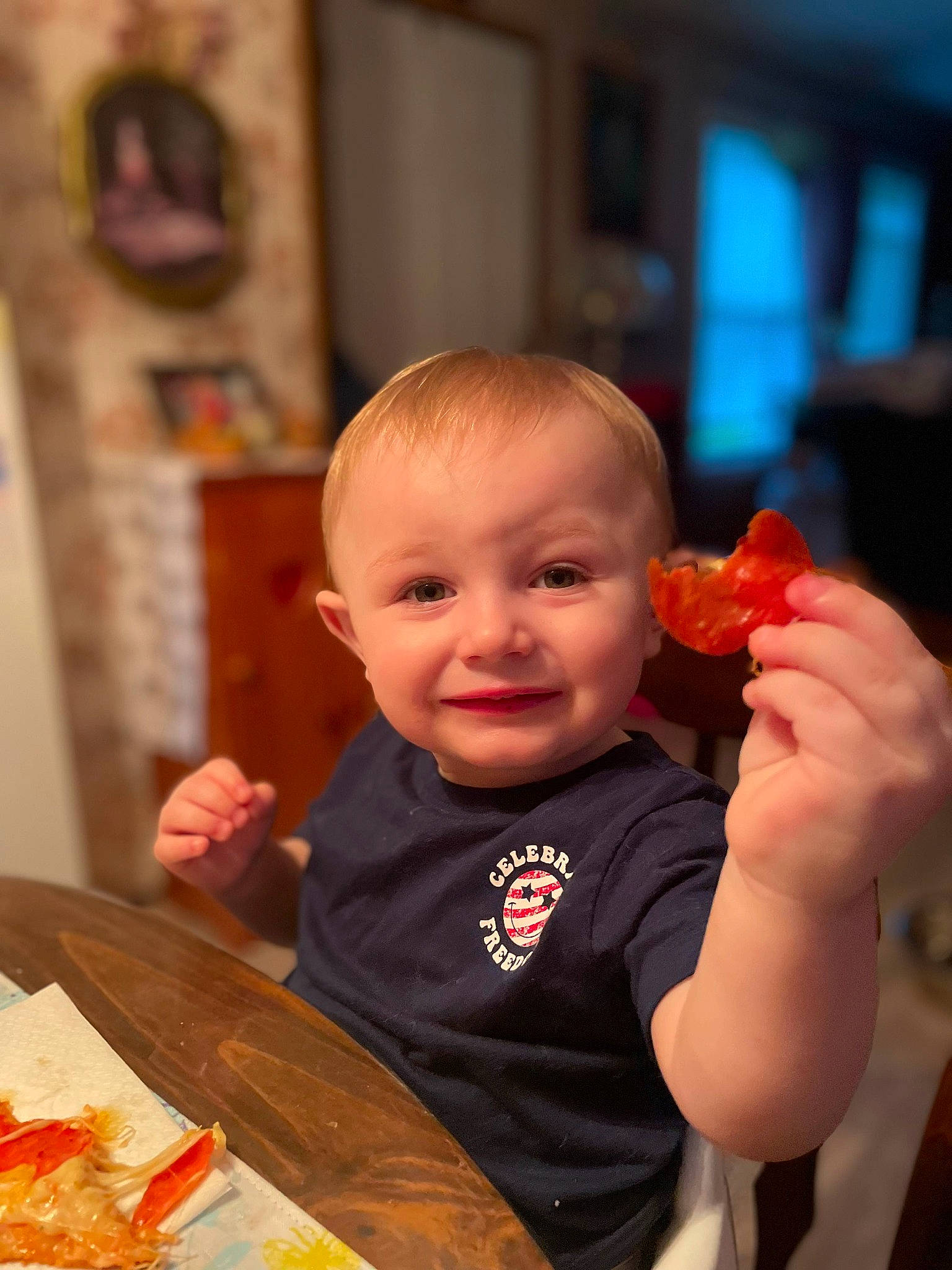 Emmett is registered to the contest to win money with this photo: baby, baby_toddler_clothing, child, comfort_food, cuisine, eating, event, face, finger_food, food, food_craving, fun, gesture, happy, joy, junk_food, orange, person, plate, smile