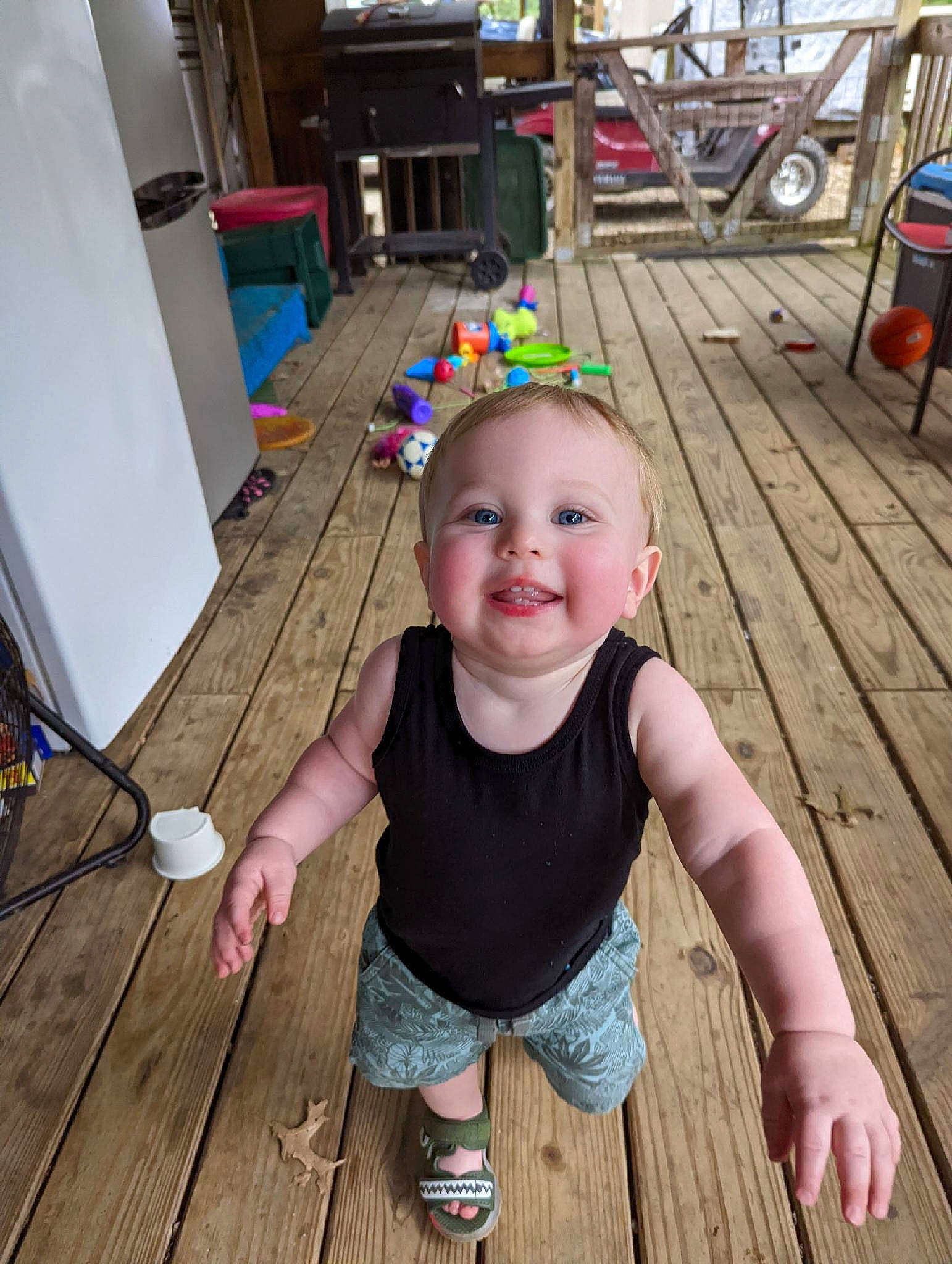 Nicholas is registered to the contest to win money with this photo: baby_laughing, baby_toddler_clothing, child, deck, event, floor, flooring, fun, grass, happy, hardwood, joy, leisure, person, plank, sitting, smile, thumb, toddler, varnish