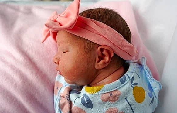 Evelynn is registered to the contest to win money with this photo: baby, baby_products, baby_toddler_clothing, cheek, child, comfort, dress, ear, eyelash, face, fashion_accessory, hair_accessory, happy, hat, headgear, pattern, peach, person, pink, sleeve