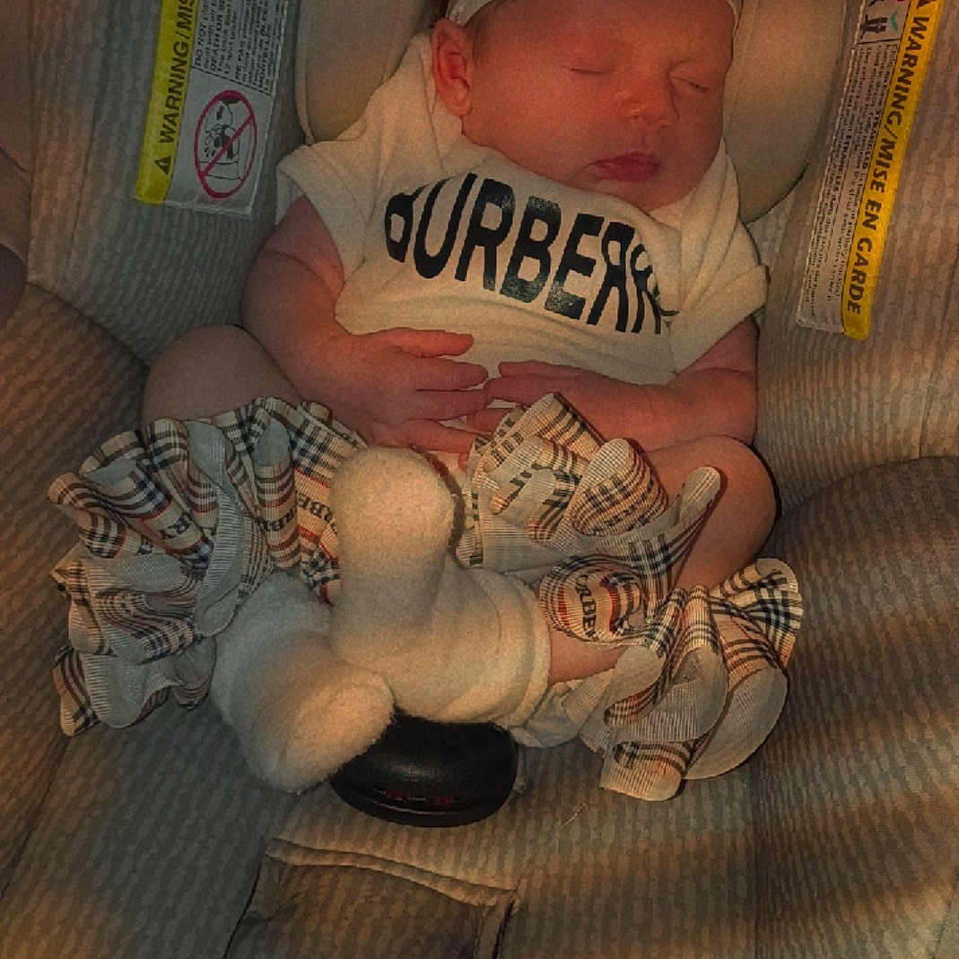 Evalyn joined the competition — help win amazing prizes! baby, bow, brand_logo, car_seat, closeup, cute, headband, indoors, infant, newborn, plaid, plush_toy, portrait, ruffles, seat_buckle, shirt, sleeping, socks, tiny_hands, warning_label