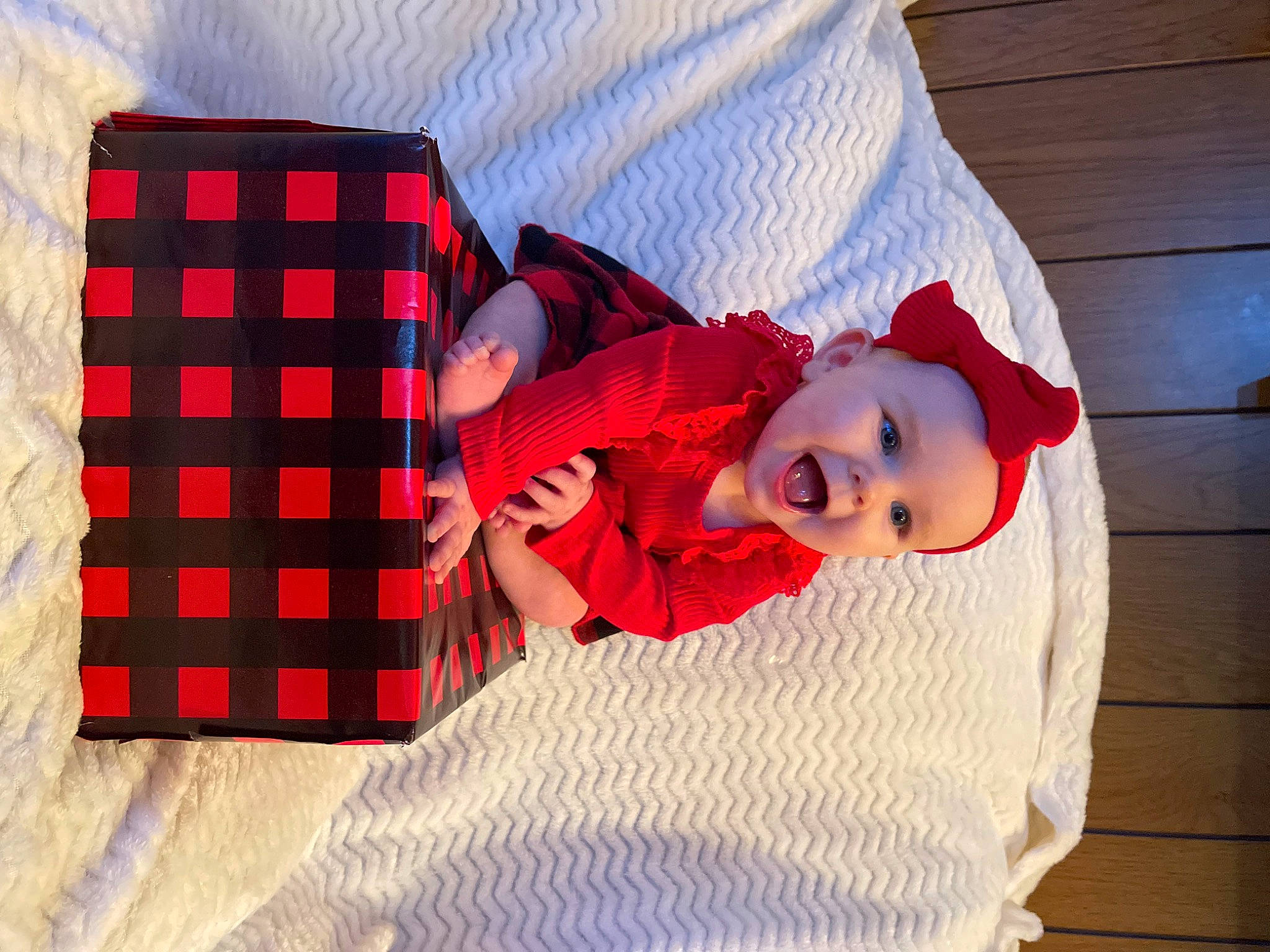 Kinslei is registered to the contest to win money with this photo: baby, baby_toddler_clothing, carmine, child, collar, comfort, electric_blue, flooring, hat, headwear, linens, magenta, pattern, person, plaid, red, sleeve, smile, tartan, textile