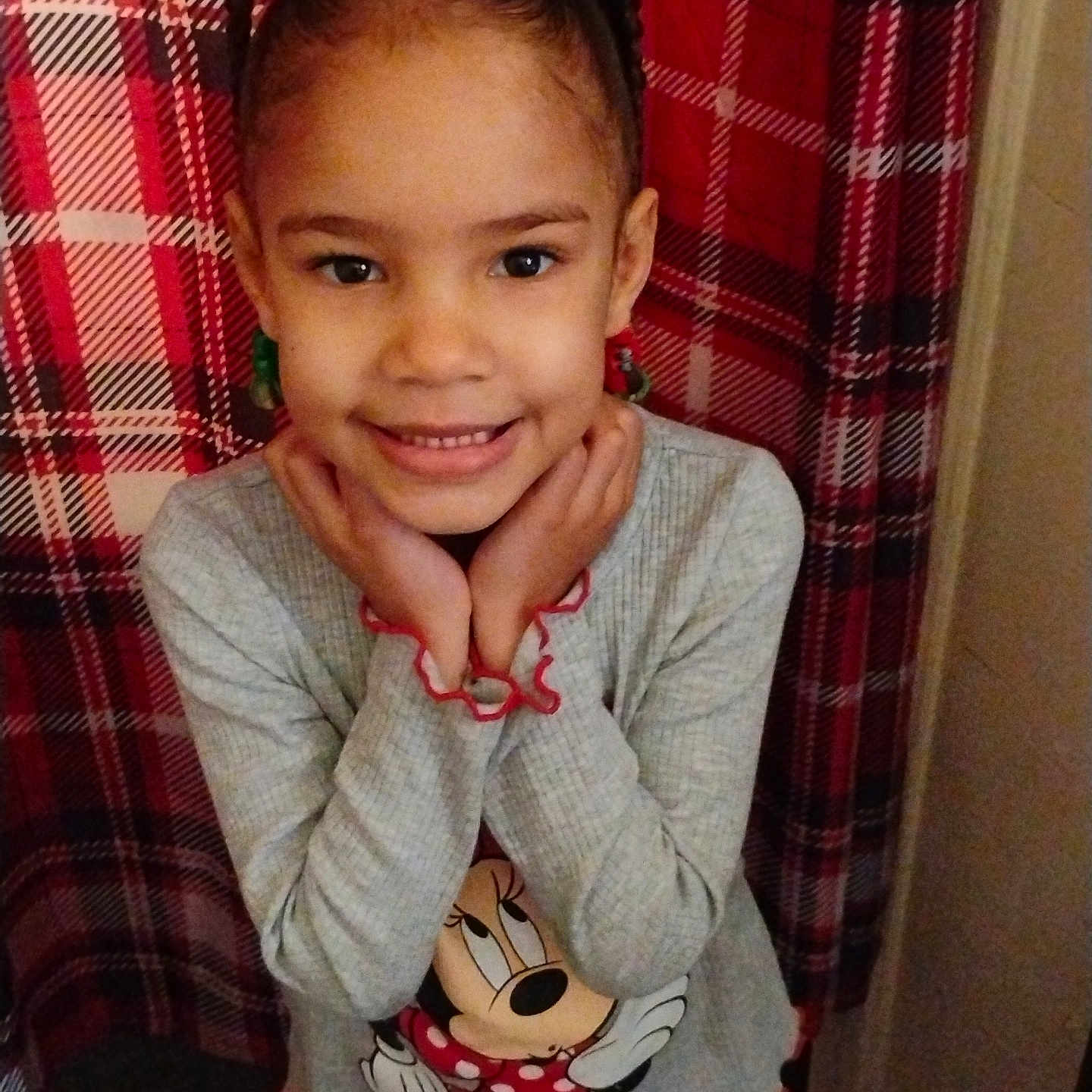 Myra joined the competition — help win amazing prizes! child, girl, smiling, pigtails, minnie_mouse, clothing, plaid_background, indoor, cute, happy, portrait, posing, long_sleeve, patterned_pants, youth, person, fashion, red, gray, casual