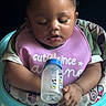 Royaltii joined the competition — help win amazing prizes! baby, child, infant, bottle, bib, high_chair, mickey_mouse, feeding, cute, sitting, clothing, face, hand, person, toy, indoor, portrait, young_child, baby_bottle, pink_bib