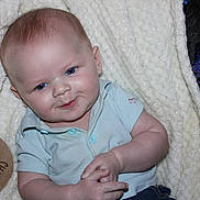 Ezra joined the competition — help win amazing prizes! baby, infant, four_months, blue_eyes, polo_shirt, smile, hands, blanket, cozy, wooden_plaque, milestone, portrait, cute, child, indoor, soft_texture, clothing, person, closeup, happy