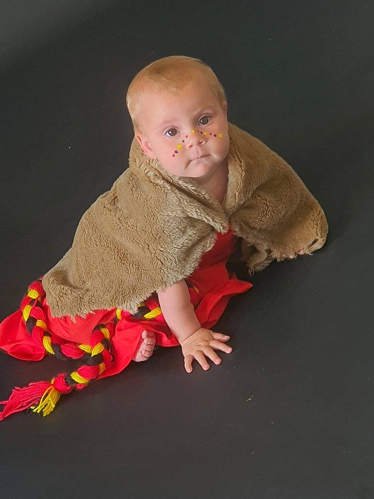 Alaia joined the competition — help win amazing prizes! baby, baby_products, baby_toddler_clothing, cheek, child, day_dress, dress, fictional_character, flooring, linens, magenta, pattern, person, petal, portrait_photography, sitting, sleeve, toddler, wood