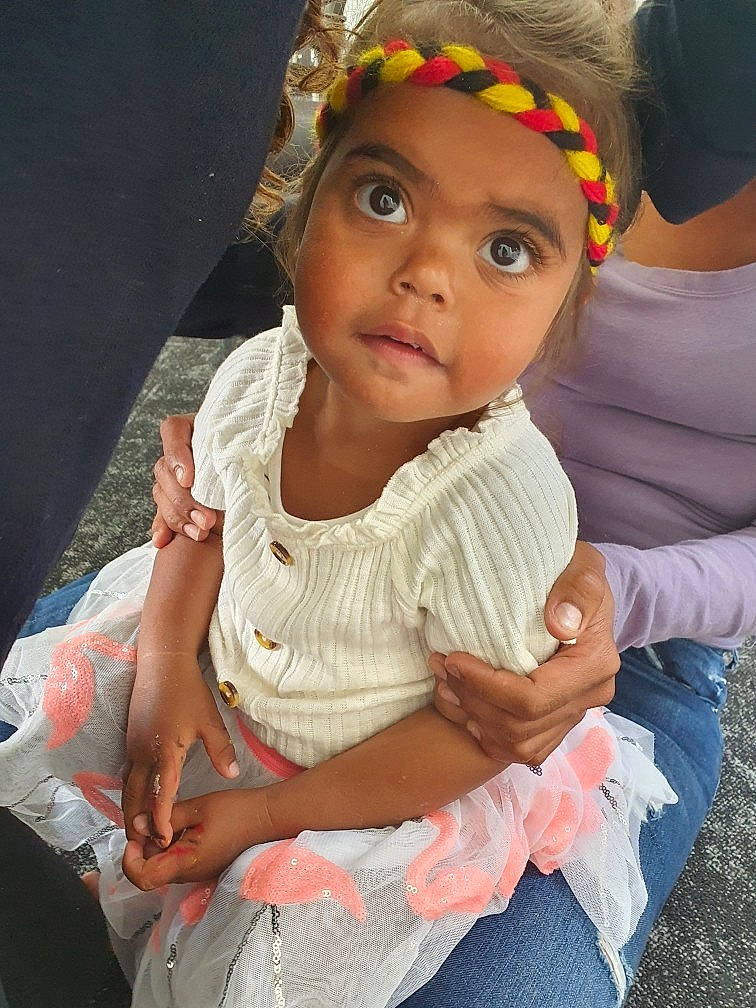 Ava joined the competition — help win amazing prizes! baby, baby_toddler_clothing, child, dress, event, face, finger, fun, gesture, grass, hair_accessory, happy, head, headband, headpiece, headwear, iris, jewellery, person, sitting