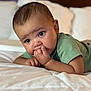 Hazen is registered to the contest to win money with this photo: baby, child, infant, bed, pillow, green_shirt, hand, face, skin, eyes, lying_down, cozy, indoors, cute, soft_lighting, expression, resting, toddler, portrait, comfort