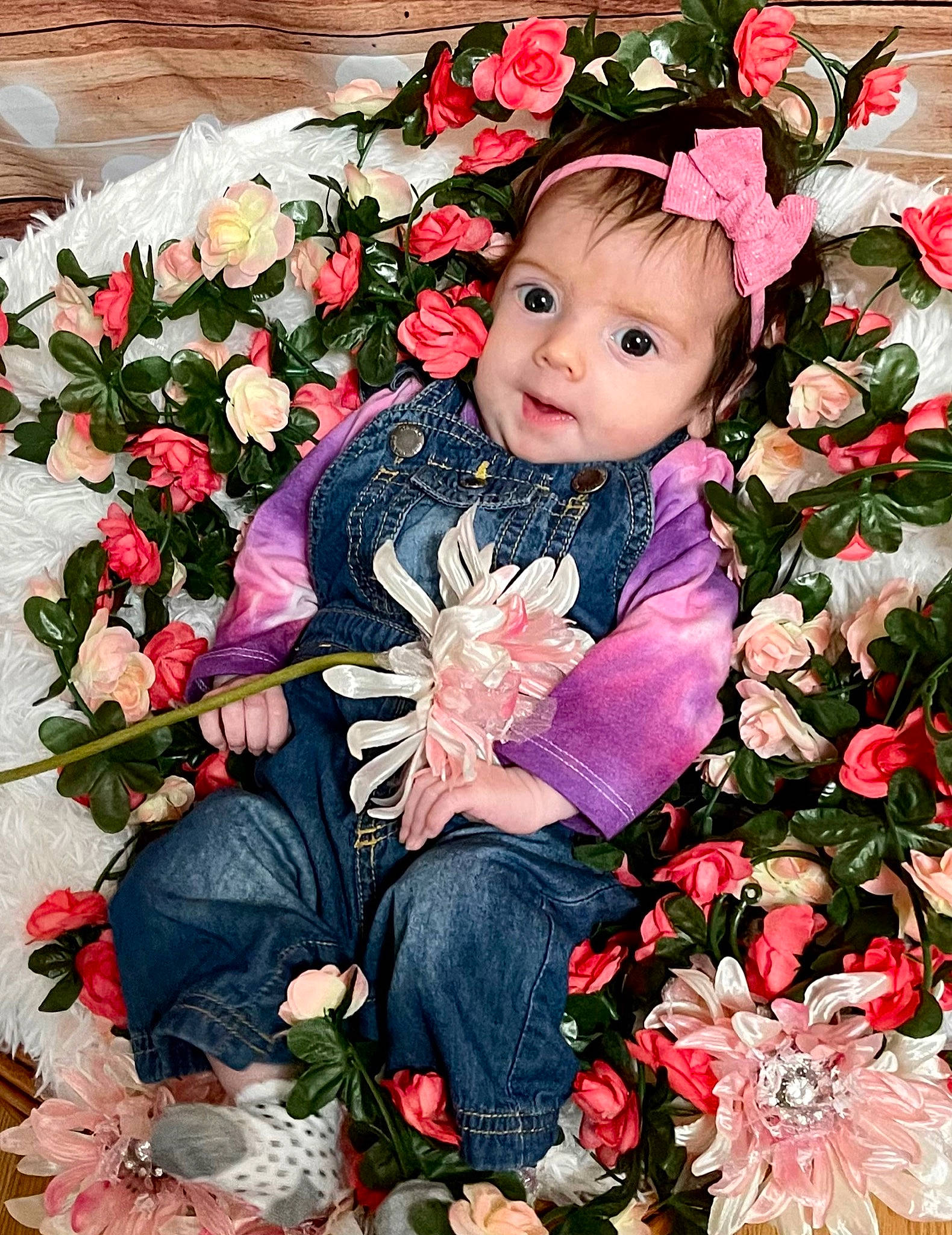 Ivy is registered to the contest to win money with this photo: baby_toddler_clothing, botany, bouquet, clothing, cut_flowers, flower, flower_arranging, flowering_plant, grass, hand, happy, iris, people_in_nature, person, petal, pink, plant, rose, rose_family, sleeve