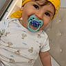 Ghaith is registered to the contest to win money with this photo: baby, bandana, bed, casual, child, clothing, cute, face, happy, headwear, indoor, infant, one_person, pacifier, person, portrait, sitting, skin, smiling, young_child