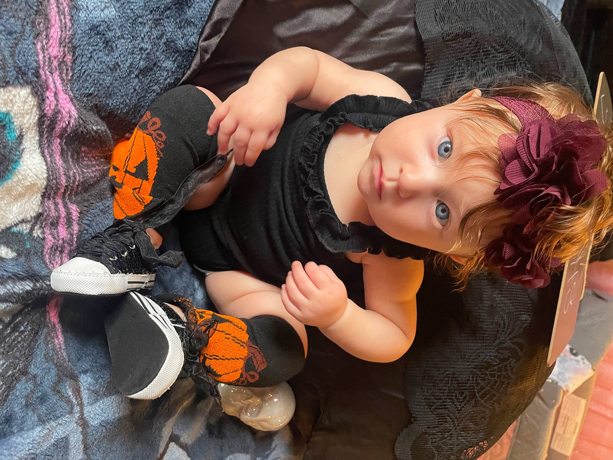 Ariana is registered to the contest to win money with this photo: calabaza, chair, child, fashion_accessory, fun, grass, happy, hat, leisure, mammal, orange, person, plant, pumpkin, sitting, toddler, toy, tree, trick_or_treat, vegetable