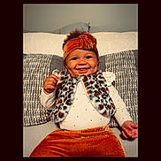 Savannah is registered to the contest to win money with this photo: baby, bodypart, clothing, couch, cushion, face, finger, furniture, hand, happy, hat, head, homedecor, knitwear, pants, person, photography, portrait, smile, sweater