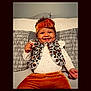 baby, bodypart, clothing, couch, cushion, face, finger, furniture, hand, happy, hat, head, homedecor, knitwear, pants, person, photography, portrait, smile, sweater