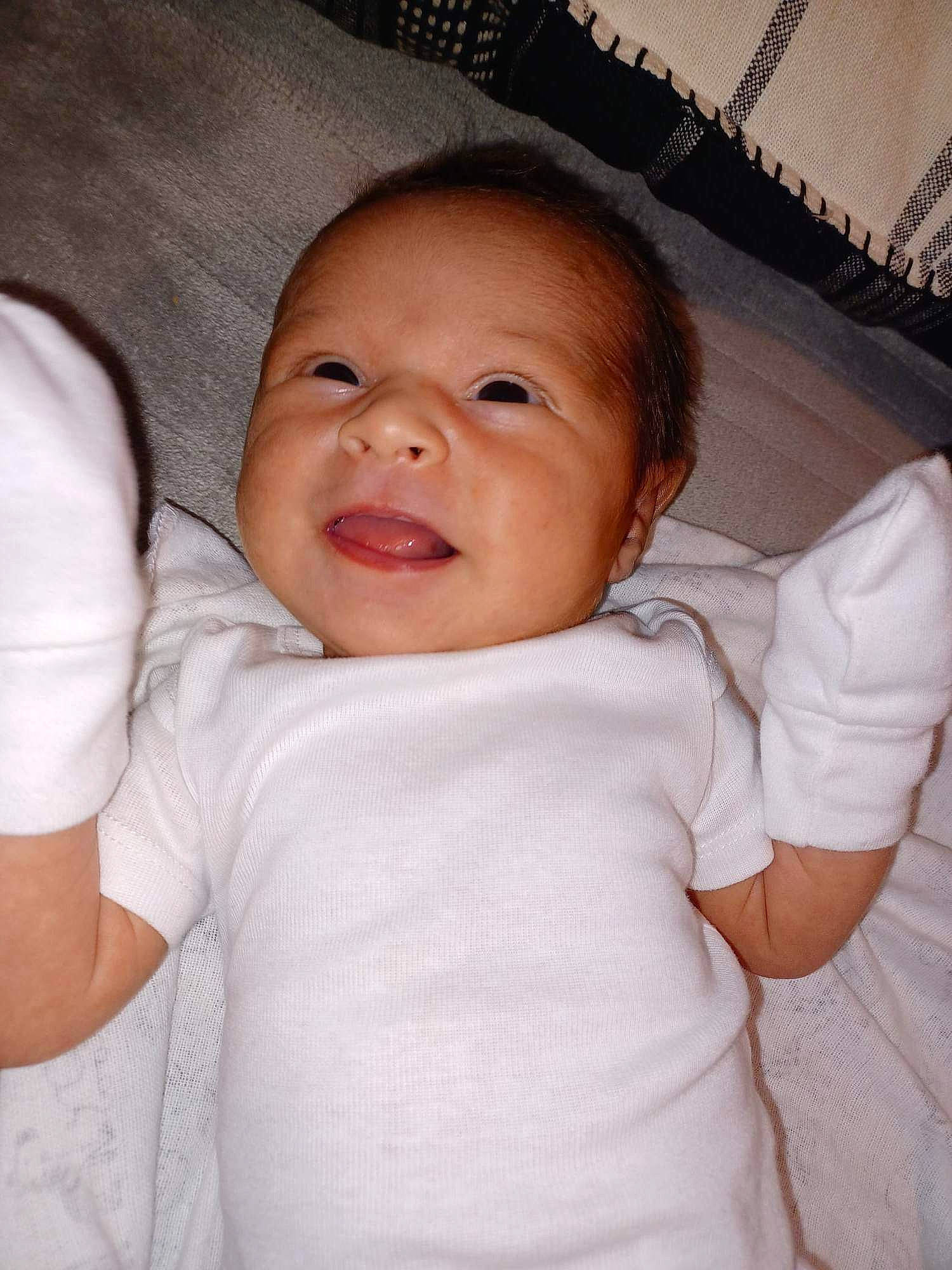 Lailani is registered to the contest to win money with this photo: baby, cheek, chin, comfort, eye, eyebrow, eyelash, facial_expression, gesture, happy, iris, lip, mammal, mouth, nose, person, skin, sleeve, smile, textile
