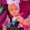 Huntleigh joined the competition — help win amazing prizes! baby, child, blue_eyes, bow, headband, pink_dress, stroller, car_seat, safety_harness, blue_spoon, hand, face, infant, cute, outdoor, sunlight, fabric, closeup, portrait, person