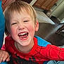 child, boy, smiling, laughing, spiderman_costume, indoor, home, carpet, wooden_cabinet, furniture, happy, portrait, cute, playful, person, face, hair, red_clothing, blue_clothing, living_room