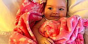 Delia joined the competition — help win amazing prizes! baby, blanket, pink, bow, headband, smile, face, hand, bed, white_bedding, soft_texture, cute, infant, child, cozy, wrapped, sleeping_area, warm, happy, portrait