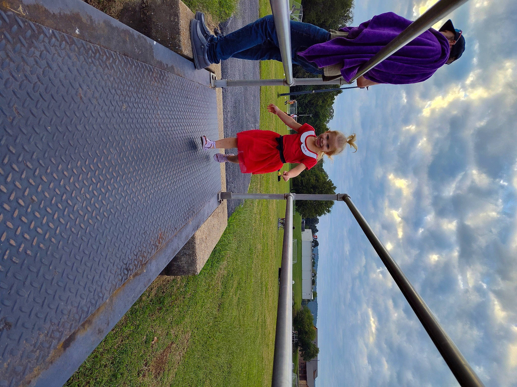 Hazelbelle is registered to the contest to win money with this photo: adventure, building, chain_link_fencing, cloud, electricity, facade, fun, grass, joy, leisure, line, mesh, person, plant, pole, public_utility, recreation, rope, sky, slope