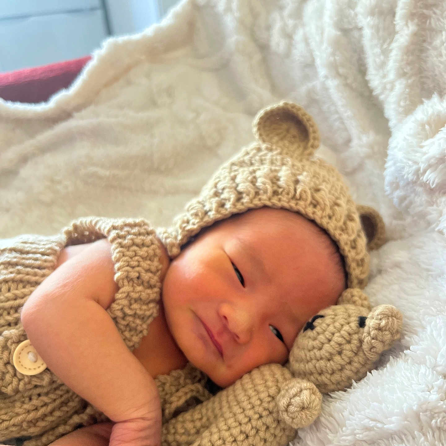 Wyatt is registered to the contest to win money with this photo: baby, bear_hat, blanket, child, comfort, cozy, crocheted_toy, cute, face, hand, indoors, infant, knitted_clothing, newborn, portrait, resting, sleepy, soft_texture, teddy_bear, warm