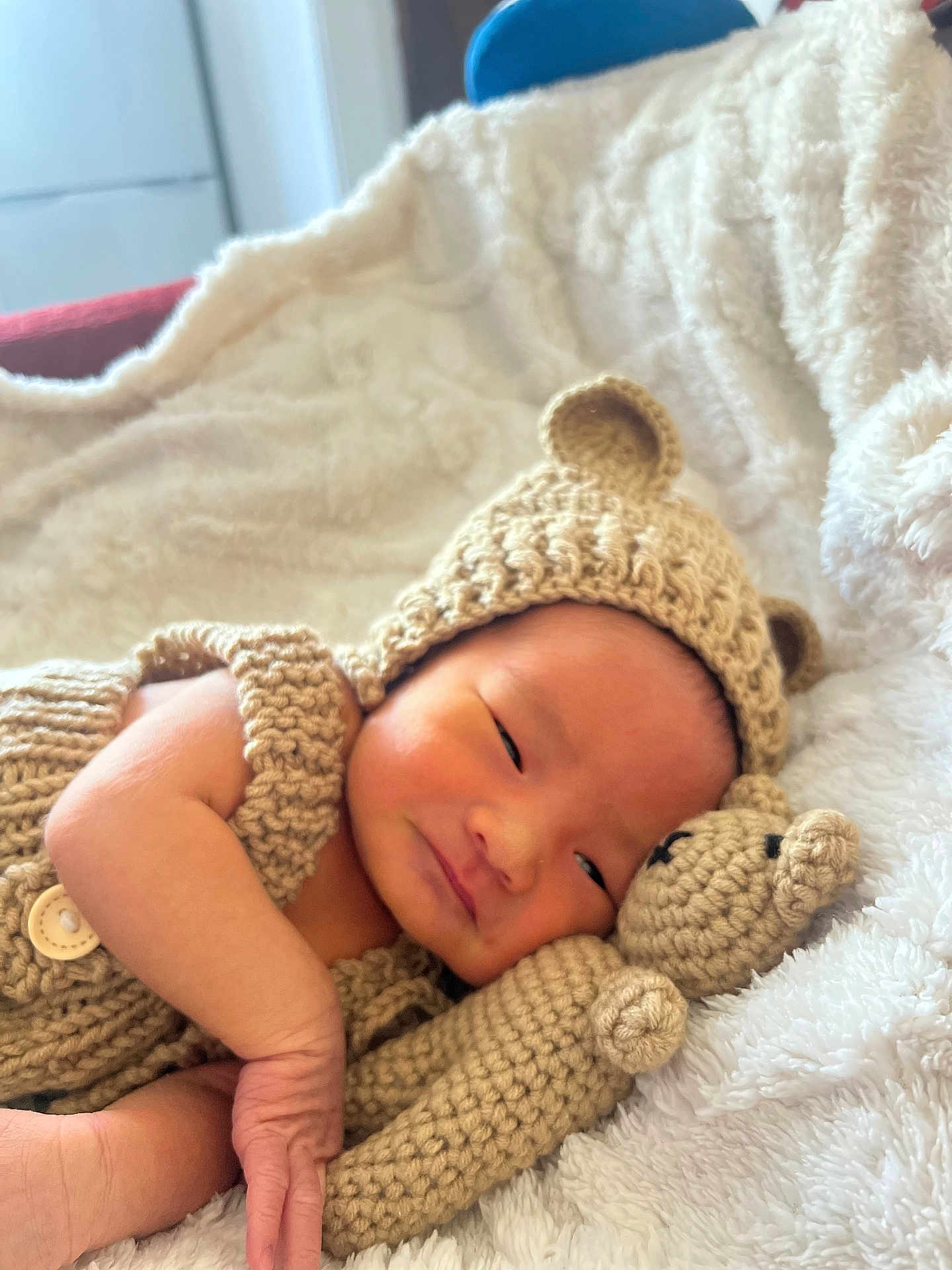 Wyatt is registered to the contest to win money with this photo: baby, newborn, knitted_clothing, bear_hat, crocheted_toy, teddy_bear, blanket, soft_texture, sleepy, infant, cute, portrait, resting, cozy, hand, face, indoors, warm, comfort, child