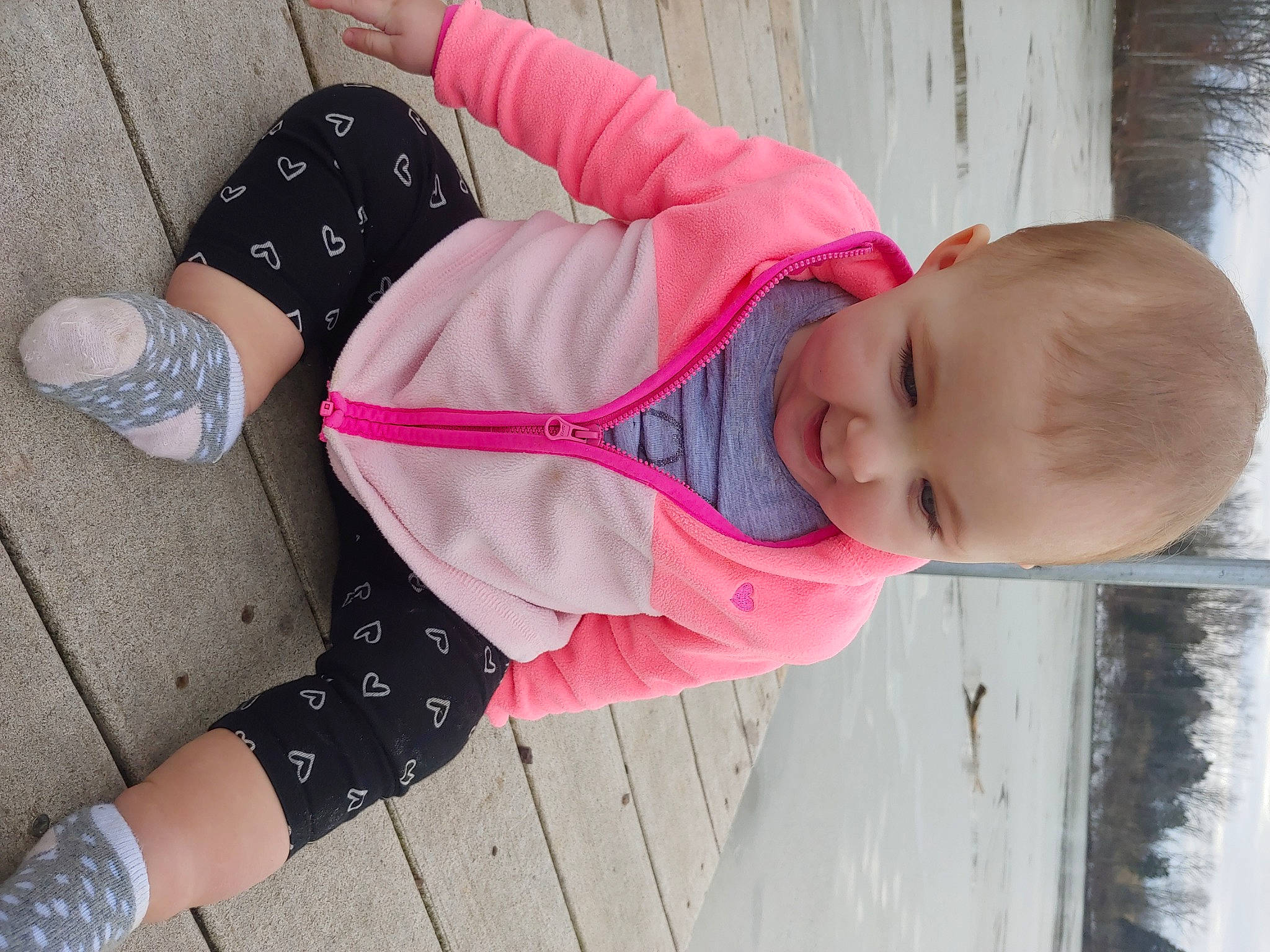 Edith is registered to the contest to win money with this photo: baby, baby_toddler_clothing, black, child, fun, human_leg, magenta, mouth, pattern, person, pink, plant, product, sitting, sleeve, street_fashion, thigh, toddler, tree, water