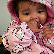 Nalani is registered to the contest to win money with this photo: baby, child, hoodie, pink, hello_kitty, cute, face, hand, clothing, portrait, indoor, toddler, warm, jacket, person, young_child, smiling, candid, young, closeup