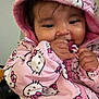 baby, child, hoodie, pink, hello_kitty, cute, face, hand, clothing, portrait, indoor, toddler, warm, jacket, person, young_child, smiling, candid, young, closeup