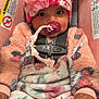 Nalani is registered to the contest to win money with this photo: baby, child, pacifier, car_seat, hat, flower, cozy_clothing, blanket, pink, floral_pattern, cute, infant, safety_harness, hand, face, portrait, indoor, warm, expression, accessory