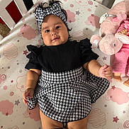 Kelsey joined the competition — help win amazing prizes! baby, child, infant, portrait, lying_down, crib, crib_mattress, headband, dress, black_and_white, patterned_clothing, socks, plush_toy, elephant, pink, stars, clouds, indoors, smiling, fashion