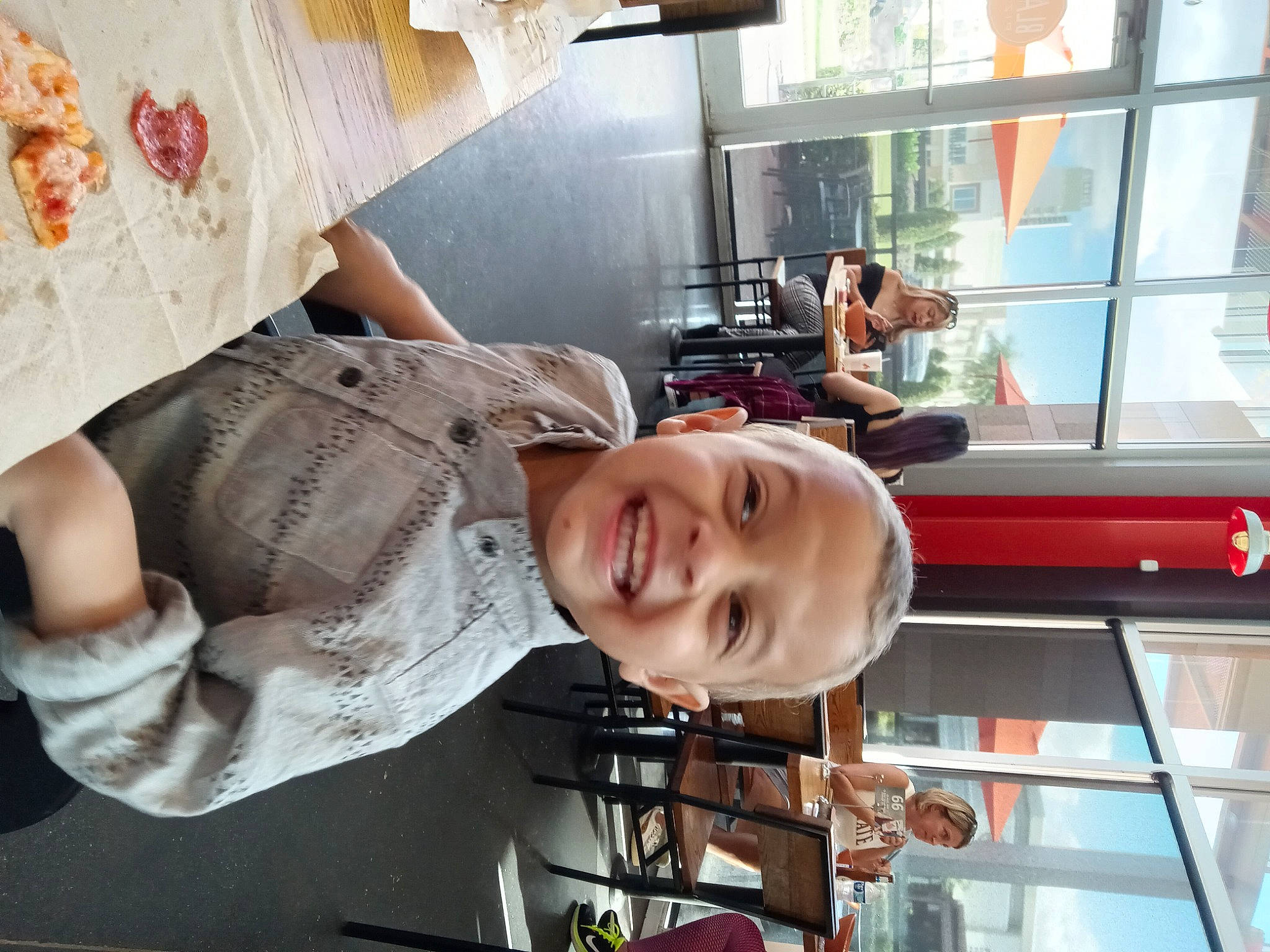 Theodore is registered to the contest to win money with this photo: arm, child, fun, happy, hat, joy, person, room, smile, snapshot, t_shirt, toddler, vacation, window