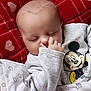 Tiago participe au concours pour gagner de l'argent avec cette photo : baby, sleeping, pajamas, mickey_mouse, blanket, heart_pattern, red, white, infant, cute, child, hand, face, cozy, soft, nap, resting, indoors, comfort, peaceful