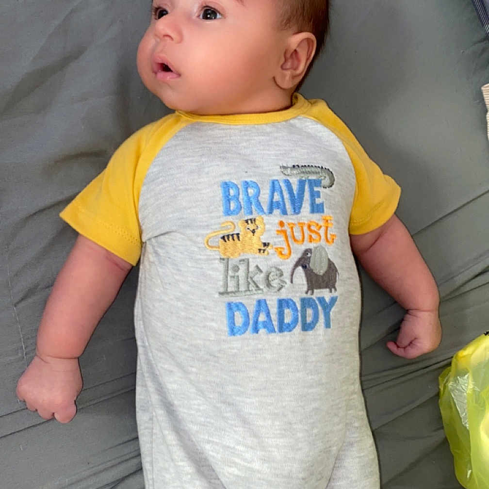 Julian is registered to the contest to win money with this photo: baby, bed, clothing, couch, cushion, face, furniture, head, homedecor, newborn, pants, person, photography, portrait, shirt, shorts, sleeping, sleeve, standing, t_shirt