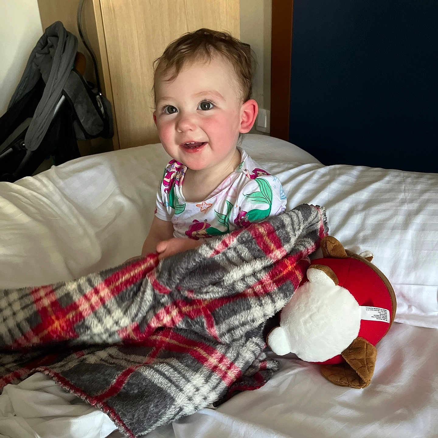 Kennedy joined the competition — help win amazing prizes! baby, bed, blanket, child, clothing, cozy, cute, furniture, happy, home, indoor, person, plaid, plush_toy, portrait, room, smile, soft_toy, toddler, wardrobe