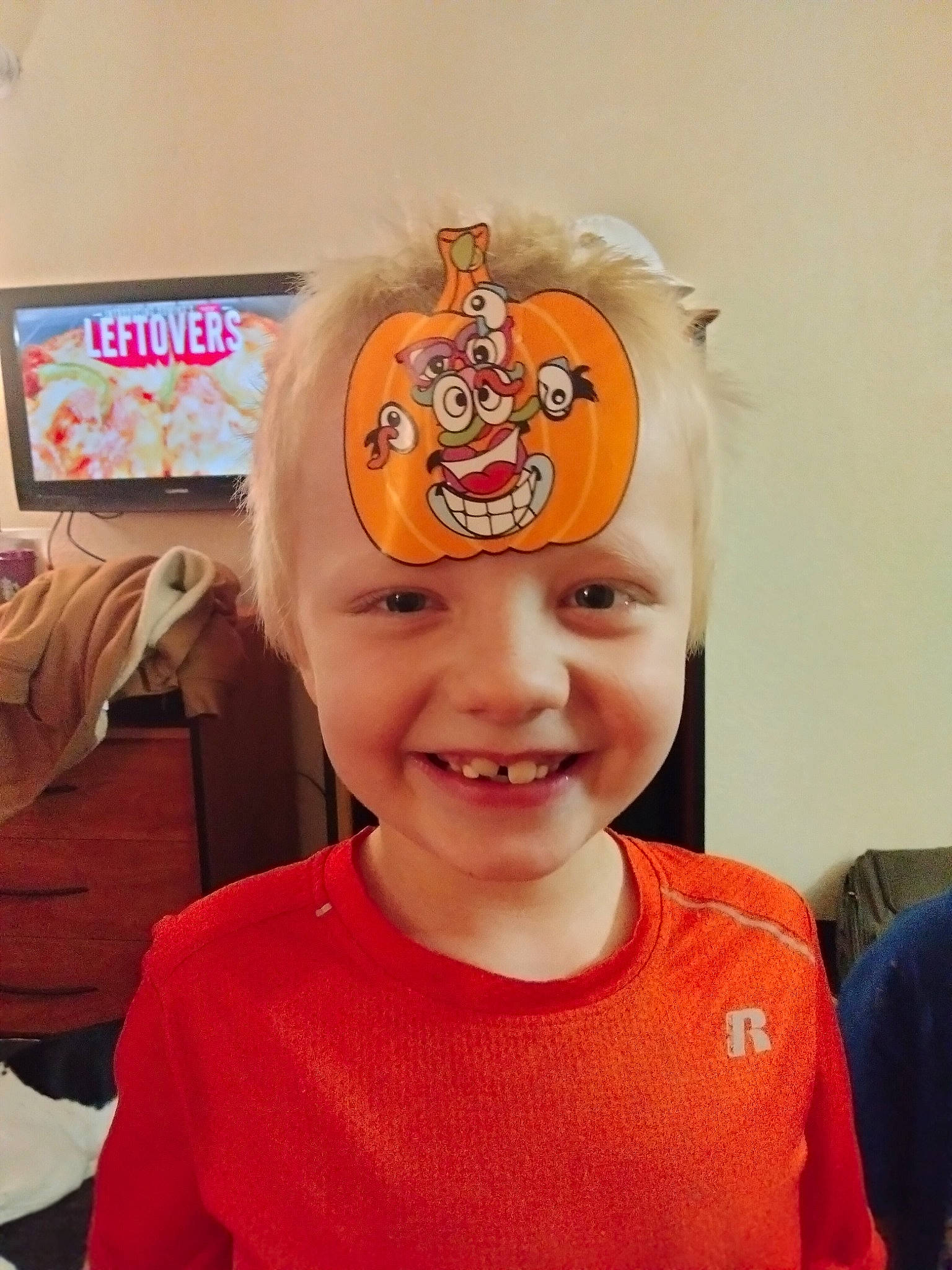 Eli joined the competition — help win amazing prizes! baby_toddler_clothing, calabaza, cap, child, costume, event, eyebrow, fashion_accessory, fun, hair_accessory, happy, headwear, joy, person, personal_protective_equipment, pumpkin, room, smile, sports_gear, t_shirt